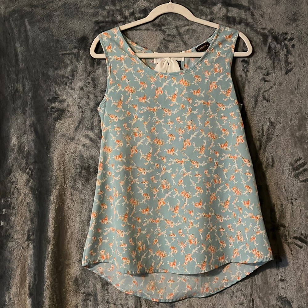 Light blue and peach flowers tank top with cream bow tie in the back
